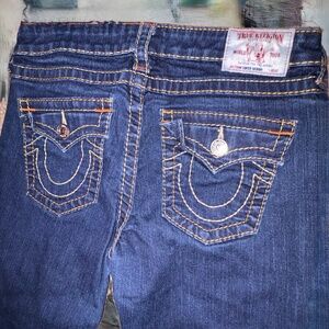 True Religion women's denim jeans with back flap pockets and contrast stitching.